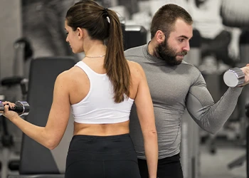 Couple lifting dumbbell to show strength