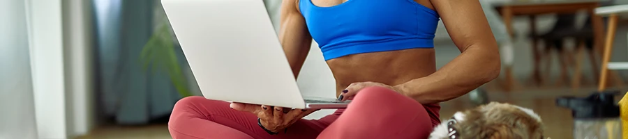 Fit woman using a laptop