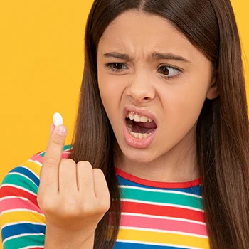 A teenager shocked while holding a pill