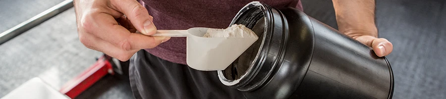 Getting a scoop from a supplement powder container