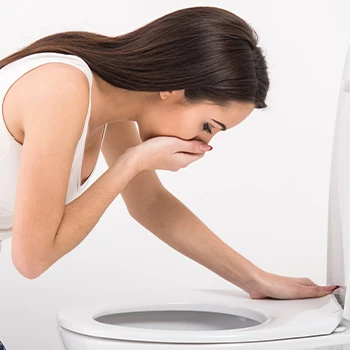 Woman vomiting from nausea