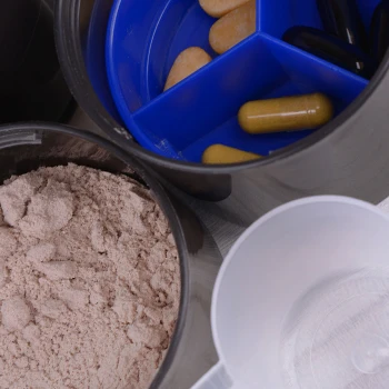 A bucket of powder supplements and pills