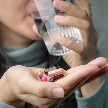 Woman drinking supplements