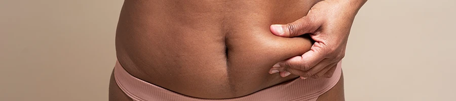 Woman pinching her stomach