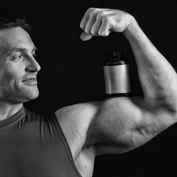 Flexing biceps carrying a supplement container