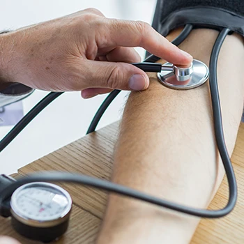 Health professional checking blood pressure