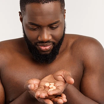 Man staring at pills