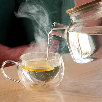 pouring hot water on a glass mug