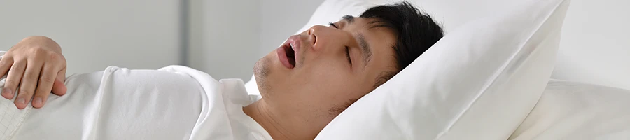 A person in deep sleep and snoring