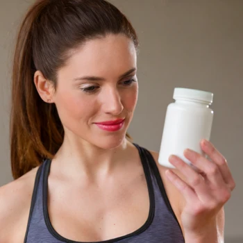 Woman holding a supplement