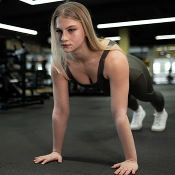 Performing a push up in the gym