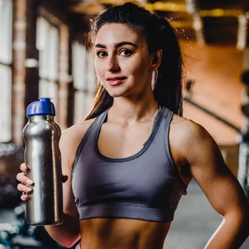 A woman holding pre workout drink