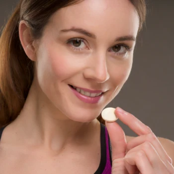 Woman holding a tablet supplement
