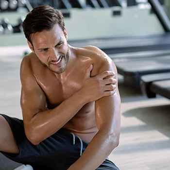 Man having a pain in gym