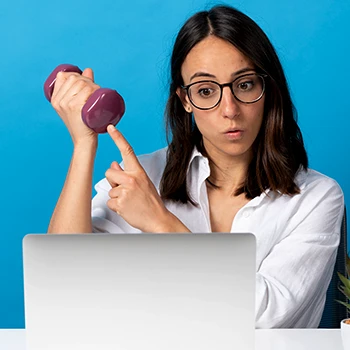 A woman pointing at her dumbbell