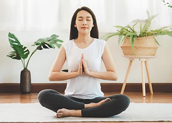 A relaxed woman in yoga mat