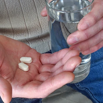 A person holding two supplement