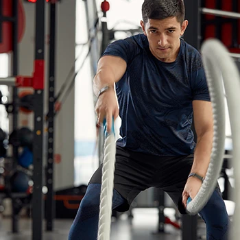 A man holding battle ropes