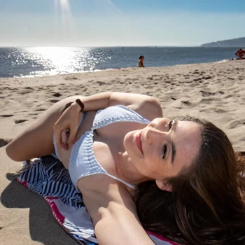 A tanned woman on a beach