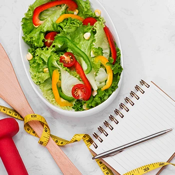 Top view of healthy vegetables with notepad