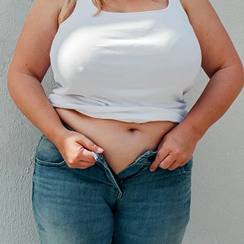 A person holding her pants