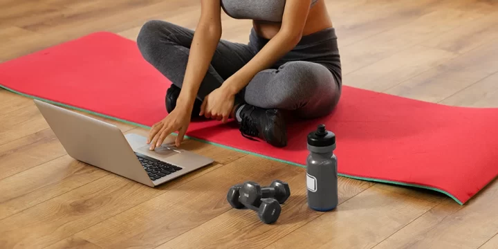 Woman using laptop during workout
