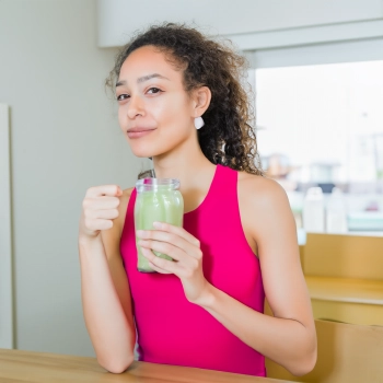 A lady holding glass of shake