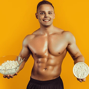 Muscular man holding two bowls