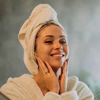 A woman looking at the mirror while smiling