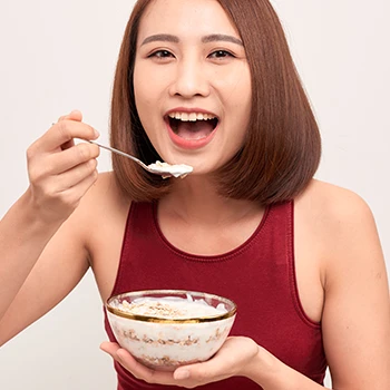 A woman eating oatmeal