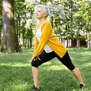 An old woman doing pilates pose