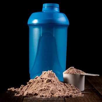 A blue tumbler with flavored protein powder