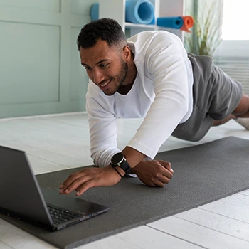 Man using his laptop during workout