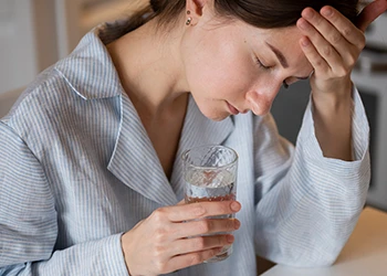 A dehydrated woman having a headache