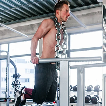 A person doing a weighted dips