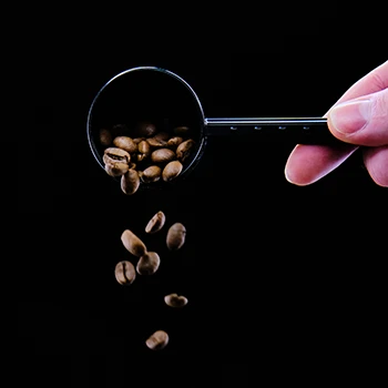 Coffee beans falling from a scoop