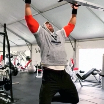 The Rock doing wide grip pull ups