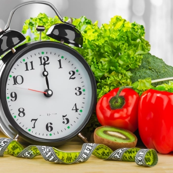 Close up shot of a clock with vegetables