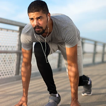 A man in a starting position for running