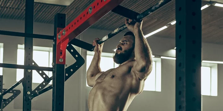 A muscular person doing pull ups