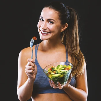 A person holding up a salad bowl and a fork