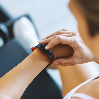 A gym person looking at her watch