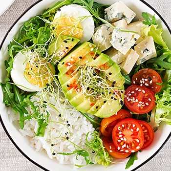 Top view of an avocado and salad