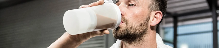 A man drinking a cold protein shake