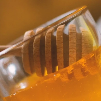 Pouring honey in a container
