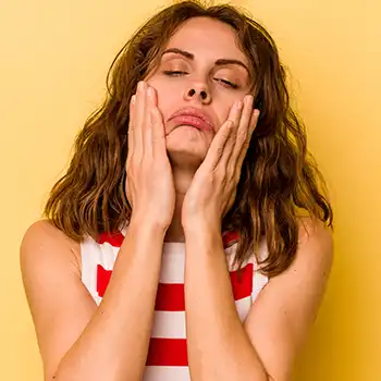 A discouraged and stressed woman in stripes