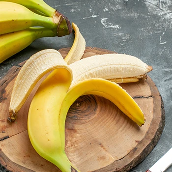 Peeled off banana on a chopping board