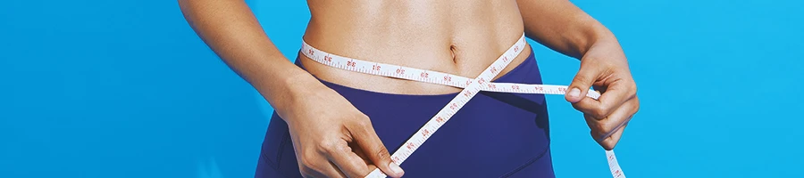 A muscular male measuring his abdominal fat