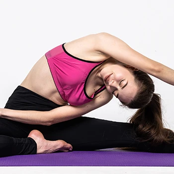 A woman doing a stretch in her yoga attire