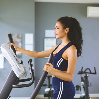 A woman working out on an elliptical machine